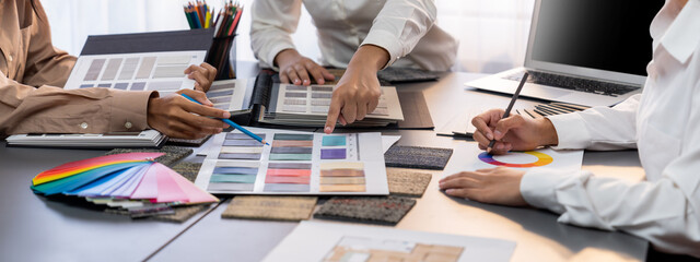 Group of professional interior designer and architect working together, planning and choosing color...