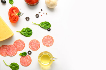 Fresh ingredients for preparing pizza on white background