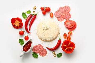 Raw dough and ingredients for preparing pizza on white background