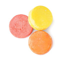 Colorful solid shampoo bars on white background