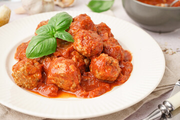 Plate of tasty meat balls with sauce on table