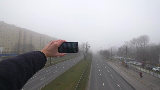 Taking picture of the morning smog in the european city in 4K slow motion 60fps