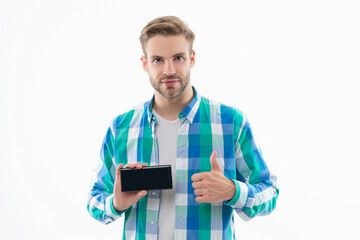 man shows phone screen in studio, thumb up. man showing phone screen on background