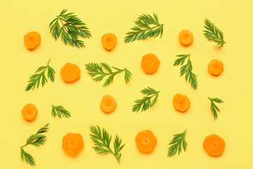 Slices of fresh carrots on yellow background