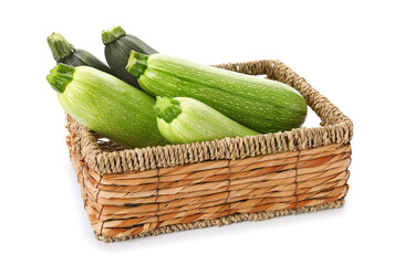 Wicker box with fresh green zucchini on white background