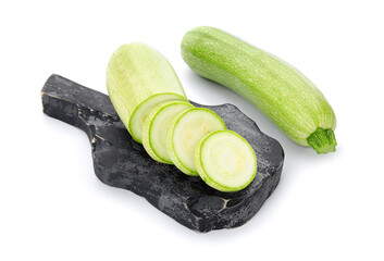 Board with slices of fresh green zucchini on white background