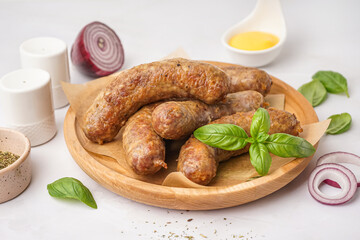 Plate of tasty homemade sausages on grey background