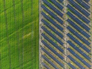Aerial view of a solar farm producing clean renewable sun energy, industrial landscape from drone