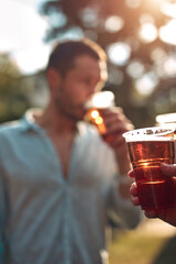 Group of friends enjoying cold beer at a backyard party.