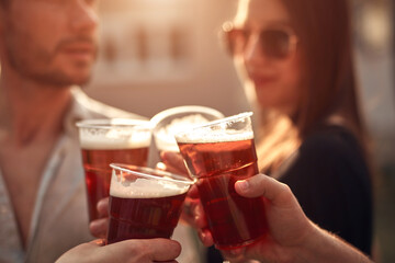 Group of friends enjoying cold beer at a backyard party.