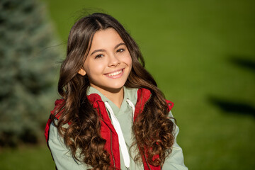 positive curly teen girl portrait. photo of curly teen girl. curly teen girl outdoor. curly teen girl