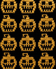 Festive Halloween crochet background. Mosaic crochet yellow black pumpkins pattern.