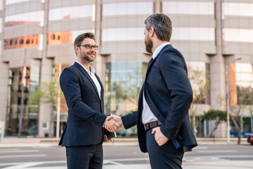 image of two businessmen deal with handshake. two businessmen deal with handshake.