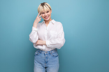 young pretty kind blond business woman in a white blouse on a background with copy space. business concept