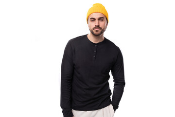handsome 30s authentic brunet male adult in black sweatshirt posing as model on white background with copy space