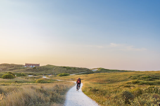 Cyling during dusk to the beach of Formerum at Wadden island Terschelling Friesland province in The Netherlands