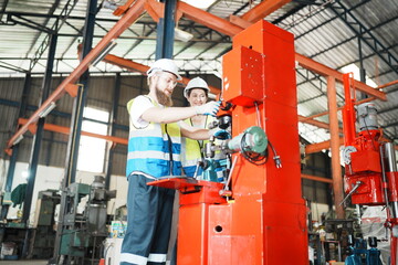 Industrial Engineer at work in factory, industrial engineers working at automated AI robotic production factory - New technology concept