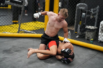 Fototapeta na wymiar Two professional boxers fighting at the gym