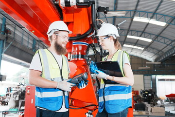 Industrial Engineer at work in factory, industrial engineers working at automated AI robotic production factory - New technology concept