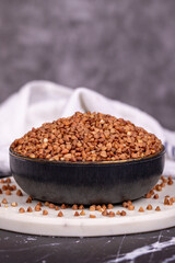 Buckwheat on dark background. Buckwheat grains in bowl