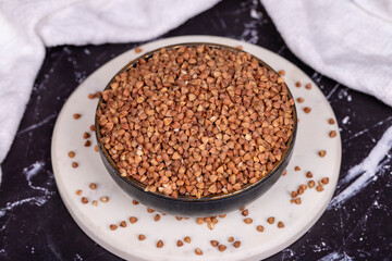 Buckwheat on dark background. Buckwheat grains in bowl