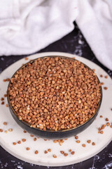 Buckwheat on dark background. Buckwheat grains in bowl