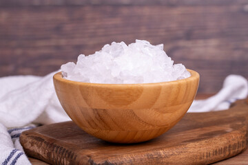 Lemon salt or Citric acid on wood background. Citric acid or lemon salt in wooden bowl