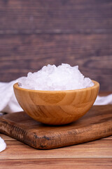 Lemon salt or Citric acid on wood background. Citric acid or lemon salt in wooden bowl