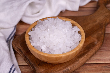 Lemon salt or Citric acid on wood background. Citric acid or lemon salt in wooden bowl