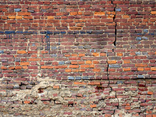 Abstract red brick old wall texture background. Ruins uneven crumbling red brick wall
