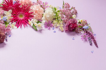 beautiful summer flowers on light purple background