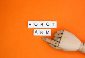 wooden hand and alphabet letters with the word robot arm. robot hand concept