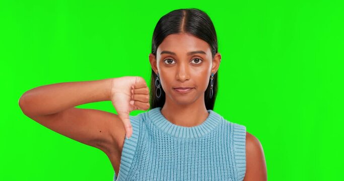 Thumbs down, green screen and face of woman with no sign, shake head or bad review in studio. Portrait, hand and indian female model with dislike emoji, wrong vote or decision of hate, reject or fail
