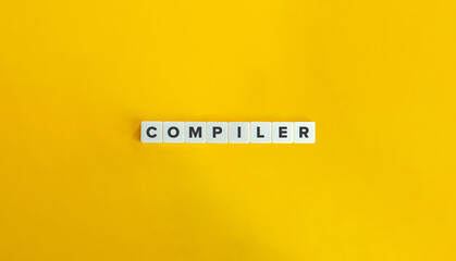 Compiler Word on Block Letter Tiles on Yellow Background. Minimal Aesthetic.