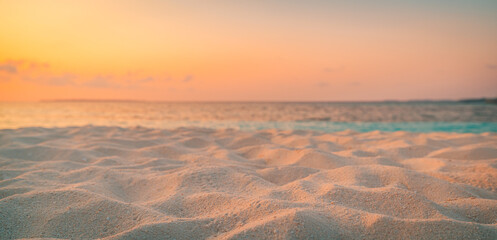 Closeup beach coast sand texture with warm gold orange sunset light. Fantasy beach landscape sky sea bay. Tranquil relax bright horizon, colorful sky. Peaceful nature seascape. Summer Mediterranean