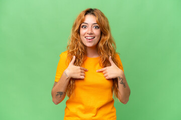 Young caucasian woman isolated on green screen chroma key background with surprise facial expression