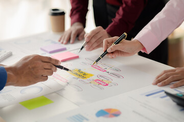 Company meeting room has businessmen and finance managers meeting together on business plan, they are looking at information on documents and discussing together. Concept business planning management.