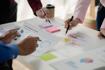 Company meeting room has businessmen and finance managers meeting together on business plan, they are looking at information on documents and discussing together. Concept business planning management.