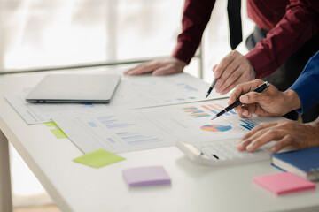 Businessman is reviewing monthly sales documents for analysis and marketing plans for more sales growth, they are the founders of young companies co-founding startups. Sales management concept.