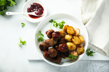 Homemade veal meatballs with potato and berry sauce