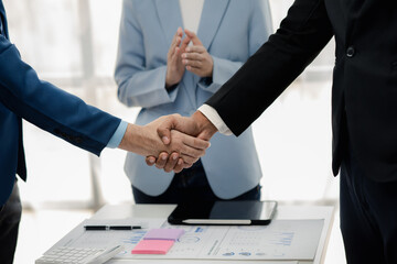 Two businessmen holding hands, Two businessmen are agreeing on business together and shaking hands after a successful negotiation. Handshaking is a Western greeting or congratulation.