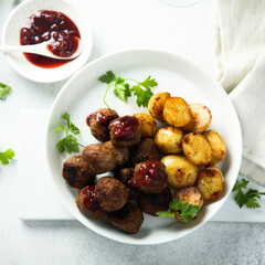 Homemade veal meatballs with potato and berry sauce