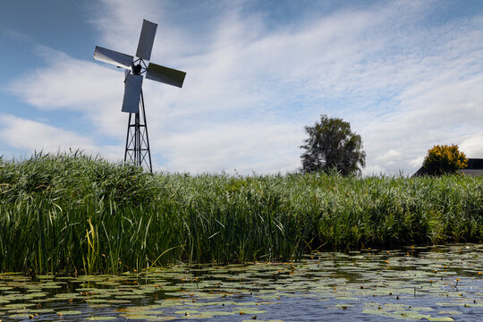 Belt Schutsloot. Near Giethoorn. National park de Wieden and Weerribben Netherlands. Waterside with reet. Windmill. Arembergergracht. Netherlands. 