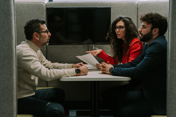 A middle-aged male manager helping his young colleagues