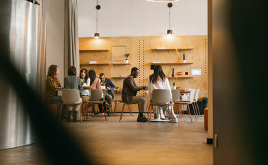 Diverse, inter-generational group of creative people working on a new project at modern co working...