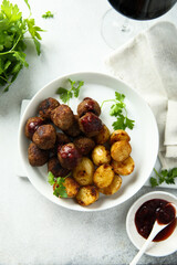 Fototapeta na wymiar Homemade veal meatballs with potato and berry sauce