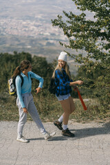 Two girls walking on a mountain's road