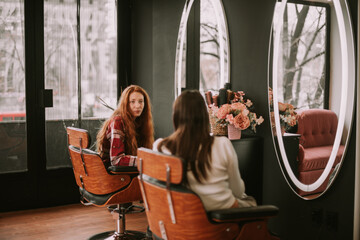 Two clients having a conversation at the hair salon