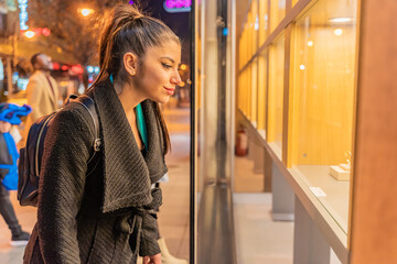 Looking at the jewelry while smiling