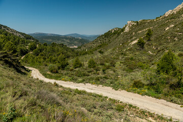 Small gravel mountain road passing over a mountain range, Costa Blanca, Alicante, Spain